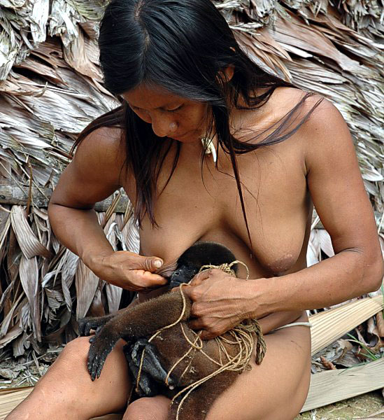 Amazonian woman breastfeeding monkey